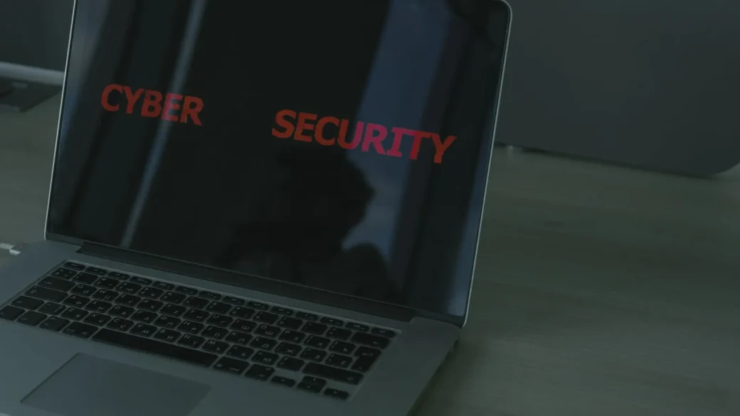 Person resetting a password on a laptop and phone