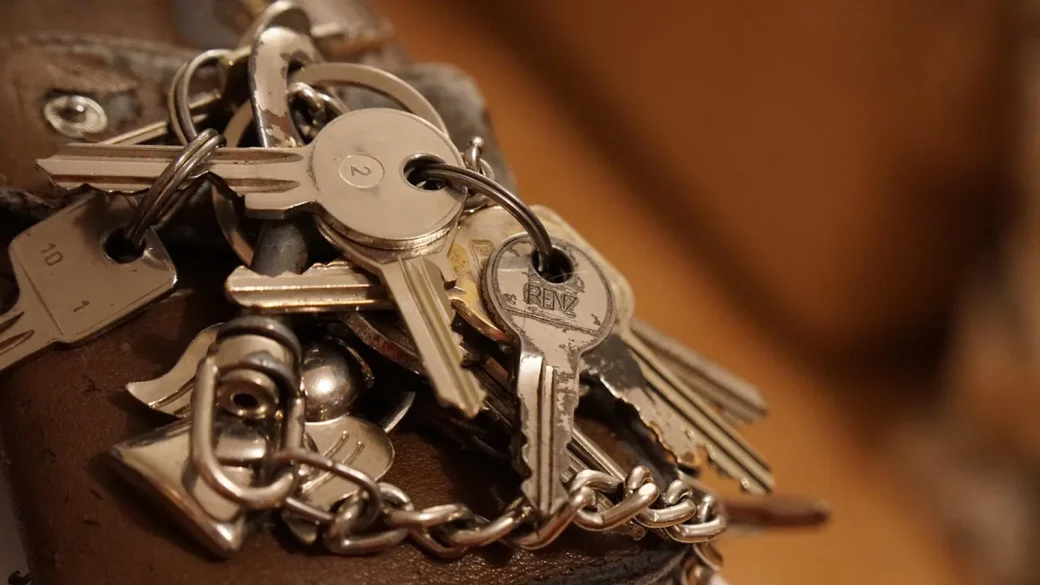 A tangle of keys on a single ring in someone's hand