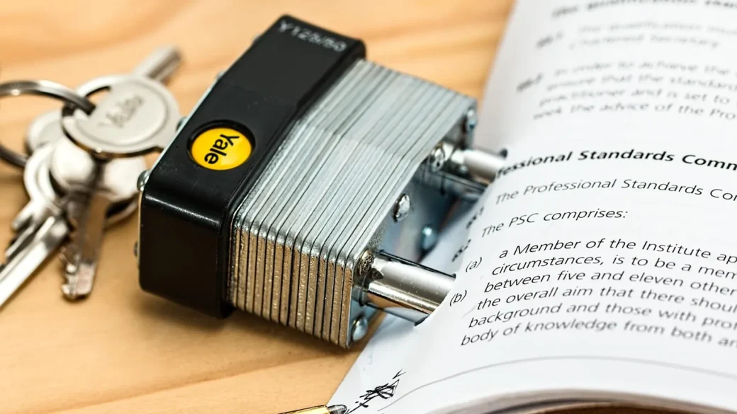padlock resting on a folder labeled credit report