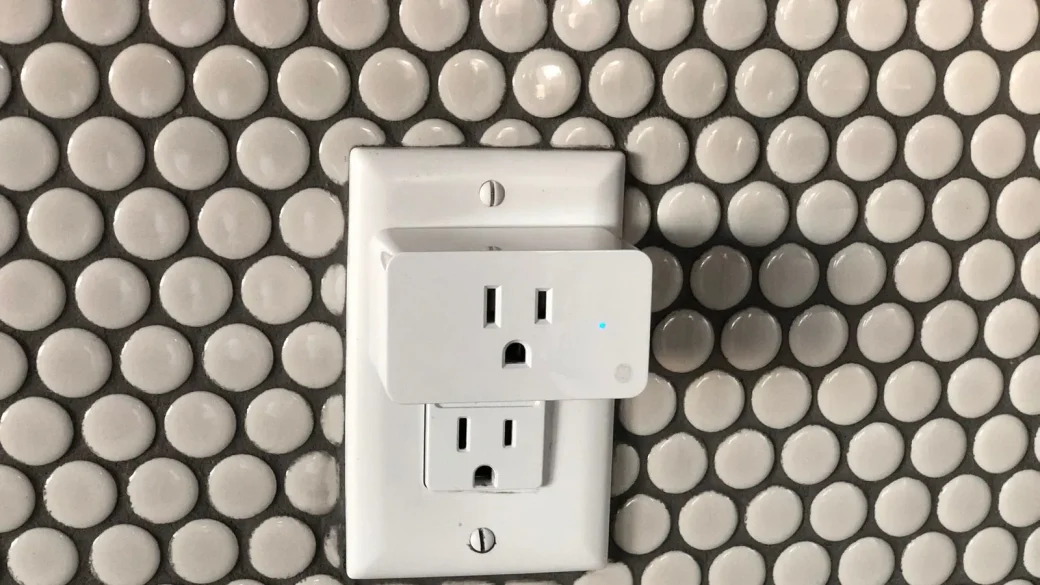 a collection of smart home devices on a shelf including a speaker and a plug