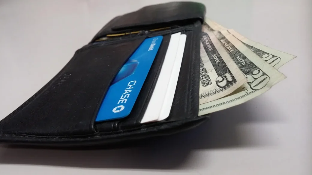 open wallet showing credit cards and cash