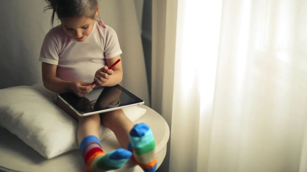 child holding a new tablet during first-time setup
