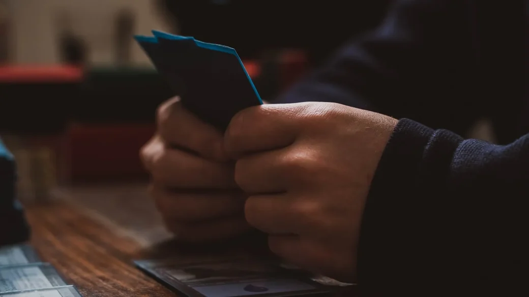 several payment cards fanned out next to a phone showing a payment app