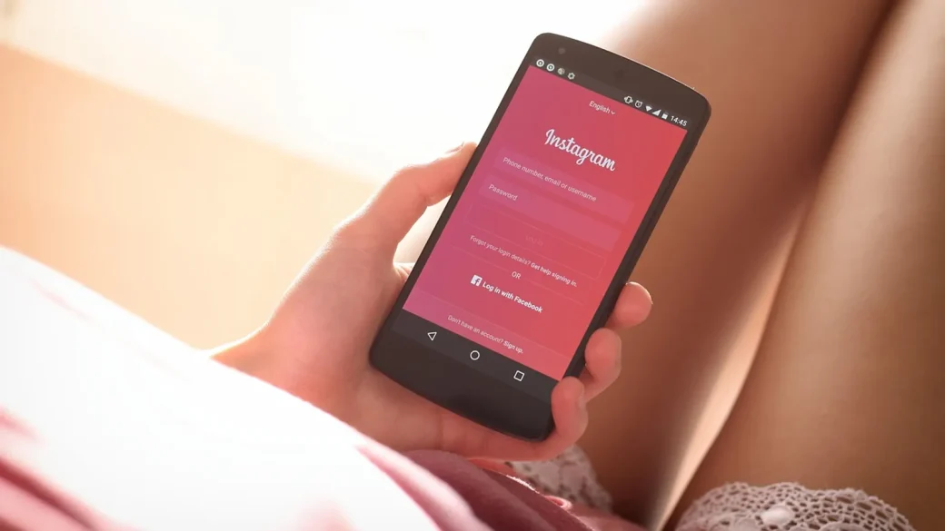 hand holding phone showing a banking app login screen