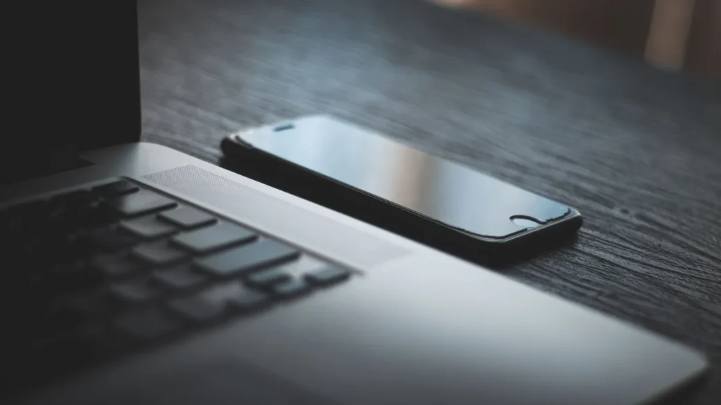 A laptop and phone on a desk ready for passkey setup