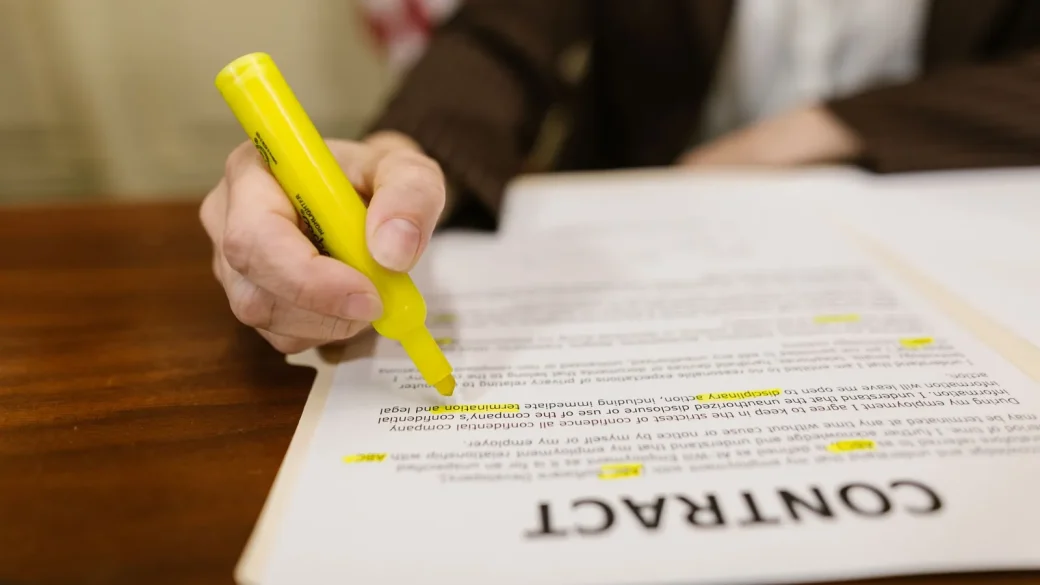 Person reviewing a credit card statement with a highlighter
